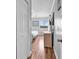 Hallway with hardwood floors leading to the bedroom with natural light at 5601 N Ocean Blvd. # B316, Myrtle Beach, SC 29577