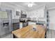 Bright kitchen with white cabinetry, stainless steel appliances, granite countertops, and an island at 5601 N Ocean Blvd. # B316, Myrtle Beach, SC 29577