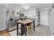White-cabinet kitchen with stainless steel appliances, an island, and neutral granite countertops at 5601 N Ocean Blvd. # B316, Myrtle Beach, SC 29577