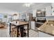 Bright kitchen featuring white cabinets, stainless steel appliances, an island, and breakfast area at 5601 N Ocean Blvd. # B316, Myrtle Beach, SC 29577
