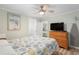 Well-lit bedroom with ceiling fan and a wooden dresser at 6001-1680 S Kings Hwy., Myrtle Beach, SC 29575