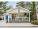 Charming beach house featuring a spacious porch with outdoor seating, string lights, and a well-maintained yard at 6001-1680 S Kings Hwy., Myrtle Beach, SC 29575