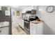 Bright kitchen features stainless steel appliances, white cabinetry, and stylish countertops at 6001-1680 S Kings Hwy., Myrtle Beach, SC 29575
