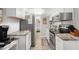 Well-equipped kitchen featuring modern appliances, white cabinetry, and stylish countertops with a view into the hall at 6001-1680 S Kings Hwy., Myrtle Beach, SC 29575