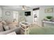 Bright living room with comfortable seating, a ceiling fan, and a view of the kitchen and bedroom areas at 6001-1680 S Kings Hwy., Myrtle Beach, SC 29575