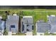 Aerial view of rooftops with solar panels overlooking lush green lawns and a tranquil pond at 6186 Chadderton Circle, Myrtle Beach, SC 29579