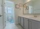Bright bathroom featuring gray cabinets, a single sink vanity, and framed animal-themed wall art at 6186 Chadderton Circle, Myrtle Beach, SC 29579
