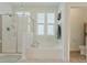 Bathroom with glass-enclosed shower and separate tub at 6186 Chadderton Circle, Myrtle Beach, SC 29579
