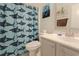 Charming bathroom featuring a shark-themed shower curtain and neutral-toned vanity with chrome fixtures at 6186 Chadderton Circle, Myrtle Beach, SC 29579