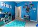 Bright blue bedroom with turquoise rug, colorful decor, and organized shelving for toys and storage at 6186 Chadderton Circle, Myrtle Beach, SC 29579