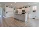 Modern kitchen with white cabinets, stainless steel appliances, and wood-look flooring at 6186 Chadderton Circle, Myrtle Beach, SC 29579
