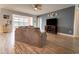 Spacious living room featuring hardwood floors, a TV, and lots of natural light at 6186 Chadderton Circle, Myrtle Beach, SC 29579