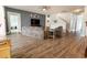 Open living room with hardwood floors, a TV, and multiple entrances at 6186 Chadderton Circle, Myrtle Beach, SC 29579