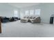 Bright and airy living room with plush neutral carpet, comfortable seating, and ample natural light from large windows at 6186 Chadderton Circle, Myrtle Beach, SC 29579