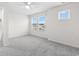 A bright, neutral bedroom features plush carpeting and large windows at 623 Harrison Mill St. # 623, Myrtle Beach, SC 29579
