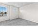 An empty bedroom offers a view of the outside through windows with grey carpet at 623 Harrison Mill St. # 623, Myrtle Beach, SC 29579