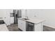 Well-lit kitchen with an island sink, stainless steel appliances, and white cabinetry at 623 Harrison Mill St. # 623, Myrtle Beach, SC 29579