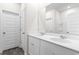 Bathroom featuring double sink vanity, large mirror, and white cabinets at 623 Harrison Mill St. # 623, Myrtle Beach, SC 29579
