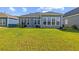 Spacious backyard showcasing the home's exterior, including a patio area with a grill and seating at 6304 Chadderton Circle, Myrtle Beach, SC 29579