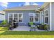 Charming outdoor patio featuring a grill, cozy seating, and a view of the well-maintained lawn at 6304 Chadderton Circle, Myrtle Beach, SC 29579