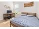 Bright bedroom with a wooden bed frame, desk and large window for natural light at 6304 Chadderton Circle, Myrtle Beach, SC 29579