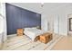 Well-lit bedroom featuring a striking blue accent wall and hardwood floors at 6304 Chadderton Circle, Myrtle Beach, SC 29579
