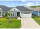 Charming home featuring well-manicured lawn, a two-car garage and inviting front entrance with beautiful landscaping at 6304 Chadderton Circle, Myrtle Beach, SC 29579