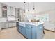 Open concept kitchen featuring quartz countertops, stainless steel appliances and an island with bar stool seating at 6304 Chadderton Circle, Myrtle Beach, SC 29579