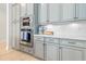 Close up of the kitchen with stainless steel appliances and well-lit quartz counter tops and stylish cabinets at 6304 Chadderton Circle, Myrtle Beach, SC 29579