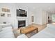 Bright living room featuring a fireplace, television, and wood floors at 6304 Chadderton Circle, Myrtle Beach, SC 29579