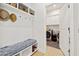 Charming mudroom with a cushioned bench, storage shelves, and access to the laundry room at 6304 Chadderton Circle, Myrtle Beach, SC 29579