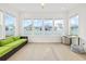 Bright sunroom with large windows, a green sofa, and a desk, perfect for relaxation or a home office at 6304 Chadderton Circle, Myrtle Beach, SC 29579