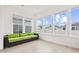Bright sunroom with large windows and a green sofa, offering a tranquil space at 6304 Chadderton Circle, Myrtle Beach, SC 29579