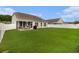 Spacious backyard with green lawn, a patio with grill, and privacy fence, perfect for outdoor enjoyment at 632 Lafayette Park Dr., Little River, SC 29566