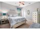 A cozy bedroom featuring a ceiling fan, a comfortable bed, and a rustic wood dresser at 632 Lafayette Park Dr., Little River, SC 29566