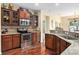 Traditional kitchen features wood cabinets, granite countertops, and stainless steel appliances at 632 Lafayette Park Dr., Little River, SC 29566