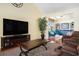 Cozy living room featuring hardwood floors, TV, and seamless flow to adjacent sitting room at 632 Lafayette Park Dr., Little River, SC 29566
