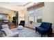Bright living room with large windows, hardwood floors, and stylish blue accents at 632 Lafayette Park Dr., Little River, SC 29566