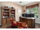 Cozy office with wooden desk, bookshelves, and a window offering natural light at 632 Lafayette Park Dr., Little River, SC 29566