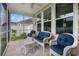 Relaxing screened porch with comfortable wicker seating, ceiling fan, and peaceful outdoor view at 632 Lafayette Park Dr., Little River, SC 29566