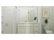 Contemporary bathroom with a vanity, toilet, shower, and neutral color palette at 6335 Swainson Street Sw, Ocean Isle Beach, NC 28469
