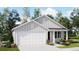 Charming single-story home with a two-car garage, well-manicured lawn, and beautiful landscaping at 6335 Swainson Street Sw, Ocean Isle Beach, NC 28469