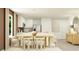 Open concept kitchen and dining room featuring white cabinetry and modern furnishings at 6335 Swainson Street Sw, Ocean Isle Beach, NC 28469