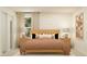Serene bedroom featuring a king-sized bed with warm bedding, complemented by matching nightstands and tasteful artwork at 6366 Swainson Street Sw, Ocean Isle Beach, NC 28469