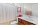 Bright bathroom features a single sink vanity, toilet, shower and pink accents at 637 Grand Cypress Way, Murrells Inlet, SC 29576