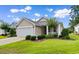 A charming single story home with lovely front yard landscaping on a sunny day at 637 Grand Cypress Way, Murrells Inlet, SC 29576