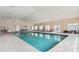 Relax in the community's bright indoor pool, featuring comfortable lounge chairs and large windows for natural light at 637 Grand Cypress Way, Murrells Inlet, SC 29576