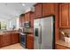 Modern kitchen with stainless steel refrigerator, range and granite countertops at 637 Grand Cypress Way, Murrells Inlet, SC 29576