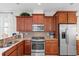 Well-equipped kitchen featuring stainless steel appliances, granite countertops, and wooden cabinets at 637 Grand Cypress Way, Murrells Inlet, SC 29576