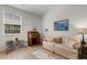 Comfortable living room with tile floors, a stylish couch, and a nearby window at 637 Grand Cypress Way, Murrells Inlet, SC 29576